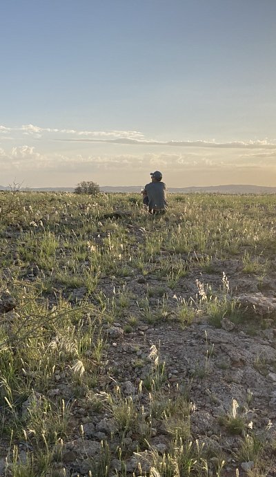 bushbundu-car-rental-windhoek-namibia-image-of-man-sitting-on-a-field